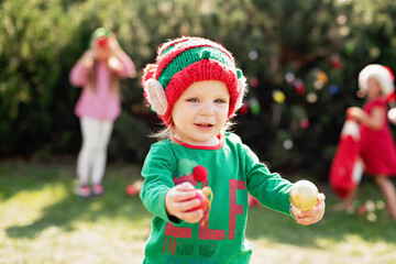 Christmas in july. children elf ears. Child waiting for Christmas in wood in july. portrait of little girl decorating christmas tree. winter holidays and people concept. Happy Holidays.