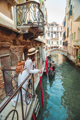 portrait of smiling woman looking at canal with gandola © phpetrunina14