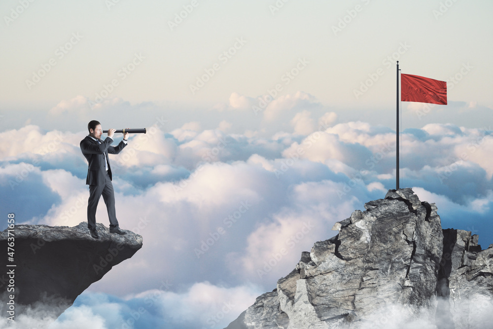 Aufkleber Abstract image of businessman with telescope looking into the distance while standing on edge of cliff, mock up place on sky with clouds background, red flag. 