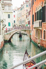 Venice, Italy - May 25, 2019: view of gondolas traffic in canal singer at boat