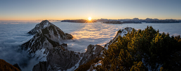 Berchtesgaden Alps at sunrise over a sea of clouds, Zwiesel summit cross, Bad Reichenhall, Bavaria, Germany