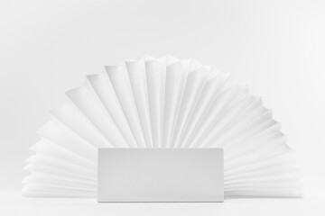 White box podium on light abstract scene mockup as showcase for displaying, presentation cosmetic product, goods with asian round white ribbed paper fan as frame in simple minimalistic style.