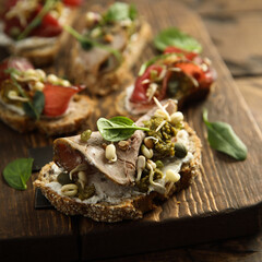 Homemade bruschetta with meat and cream cheese