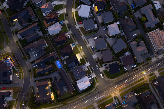 Aerial drone birds-eye view during the night evening looking down over a suburn in the city of Hamilton (Kirikiriroa), in the Waikato region of New Zealand (Aotearoa)