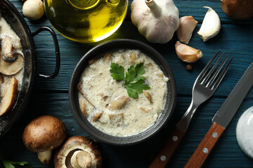Concept of tasty food with mushroom sauce on wooden background