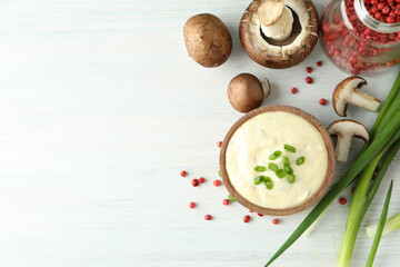 Concept of tasty food with mushroom sauce on white wooden background