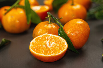 Tangerines (oranges, mandarins, clementines, citrus fruits) with leaves and fir tree branches