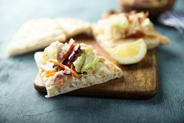 Coleslaw salad with bacon served with pita bread