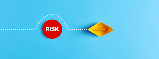 Sailing paper boat comes around the obstacle of risk. Risk avoidance in business - obrazy, fototapety, plakaty