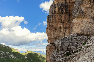 A steep cliff in the Italian Dolomites with the characteristic structure and color of the rock