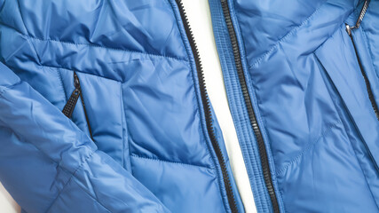 blue puffer jacket material as background close up