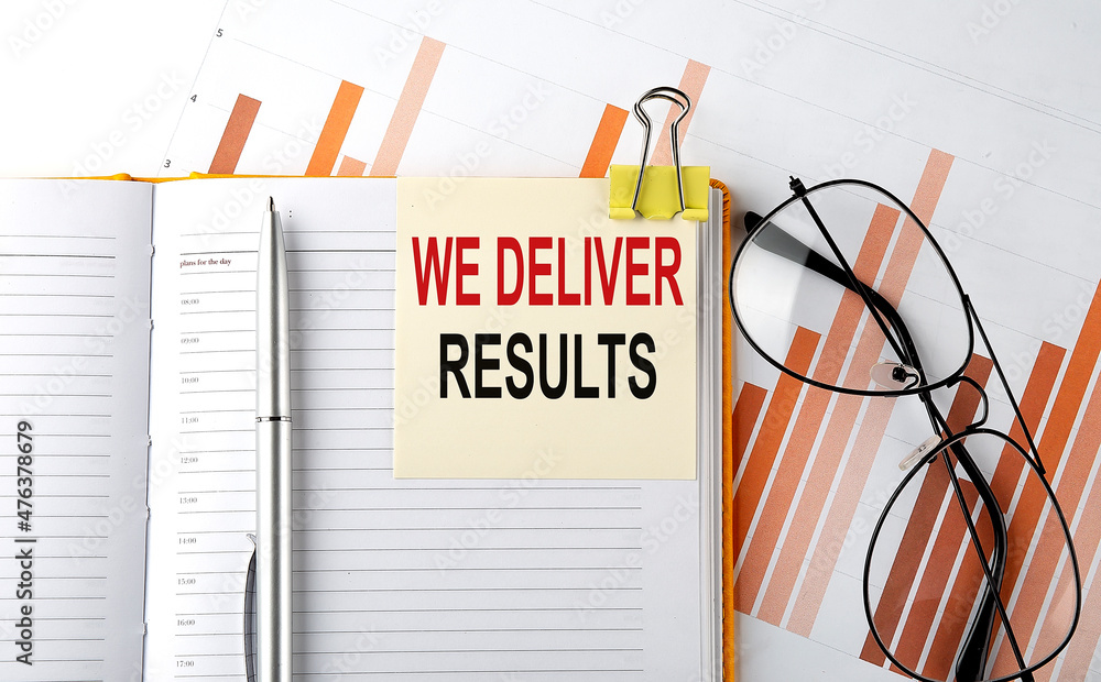 Poster text we deliver results on sticker on the notepad on diagram background
