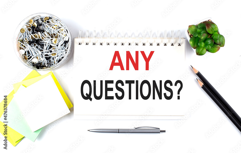Poster any questions text on notebook with office supplies on white background