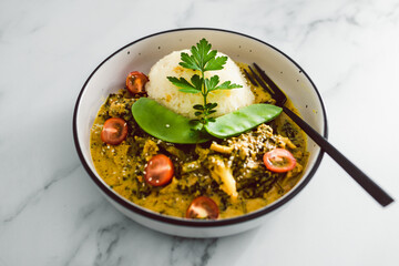 vegan thai green curry with rice and mixed vegetables, healthy plant-based food