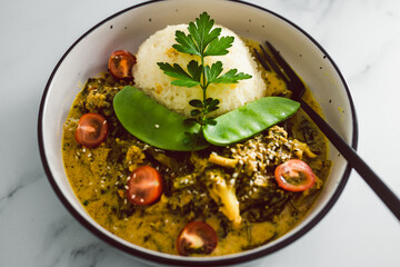 vegan thai green curry with rice and mixed vegetables, healthy plant-based food