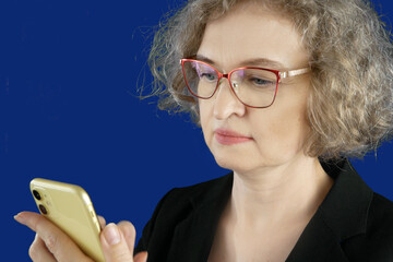 business woman in suit using mobile phone on blue chromakey background, small business entrepreneur...