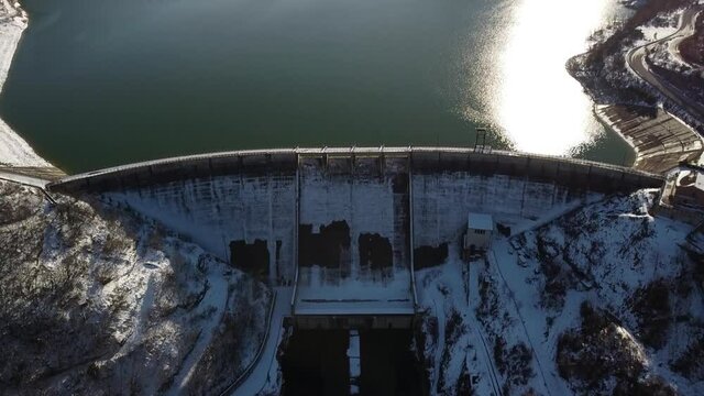 aerial footage - flying above an italian dam located in the village of Cingoli in winter