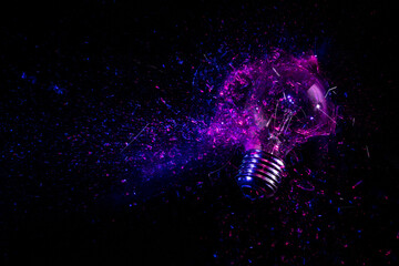 explosion of an electric light bulb on black.