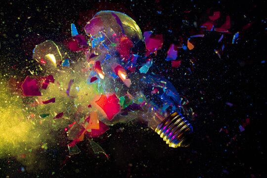 explosion of a colorful light bulb on black.