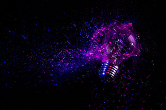 explosion of an electric light bulb on black.