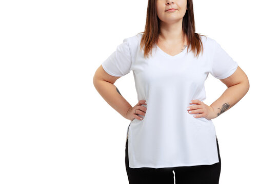 Cropped image of plus-size woman wearing white t-shirt and jeans posing isolated on white studio background.