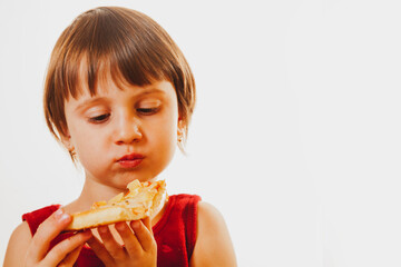 Beautiful child girl enjoys delicious slice of pizza, likes this taste, she has good appetite. Horizontal image. Copy space.