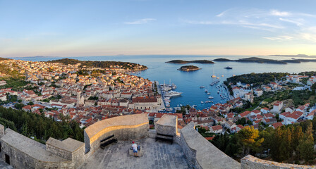 Streets of historic and tourist town of Hvar with fort, port and yacht marine, Croatian island otok...