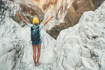 Happy woman wearing protective helmet raised her hands on admiration while she is engaged in...