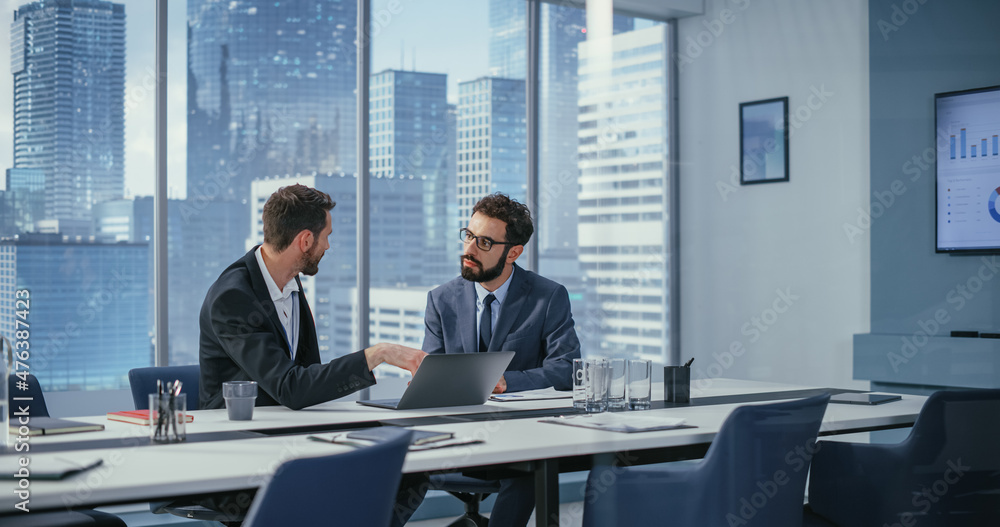 Poster businesspeople in office: business meeting of two businessmen using laptop computer and talking. tec
