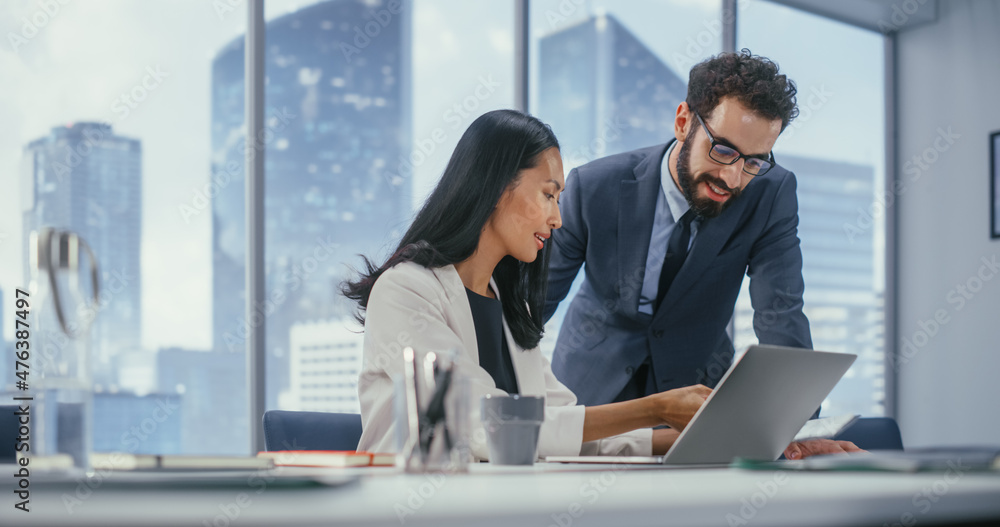 Wall mural Modern Office: Portrait of Successful Corporate CEO and Top Manager Talk, Use Laptop Computer. Businesspeople Discuss Investment in Digital e-Commerce Fintech Startup. Multi-Ethnic Working Environment