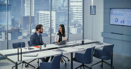 Businesspeople in Modern Office: Businesswoman and Businessman Use Laptop Computer, Talk. Top Manager and Partner Investor Discuss e-Commerce Software Global Investment Strategy.