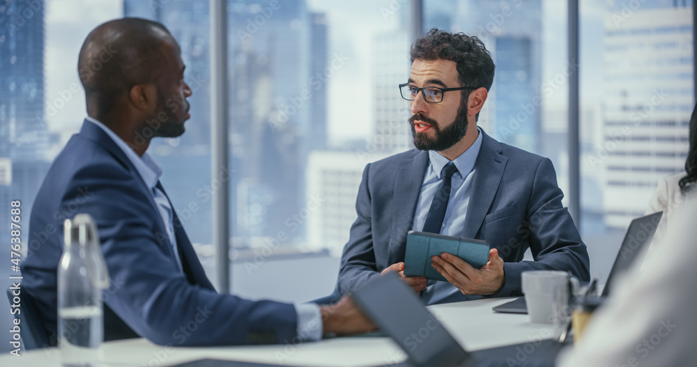 Poster Modern Multi-Ethnic Office Conference Room Meeting: Caucasian Top Manager Talks to Black Executive, Brainstorming, Forming Strategy, Using Tablet Computer to Find Solution. Medium Portrait