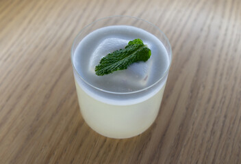 Refreshing cocktail with mint on a wooden table