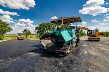 Laying a new asphalt on the road. Construction of the road.