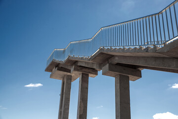 Concrete stairway to heaven. Metal railing.