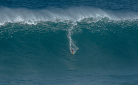 Sport photography. Jaws swell on International surfing event in Maui, Hawai 2021 December.