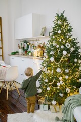 child decorating christmas tree