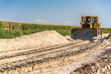 The bulldozer performs excavation work.