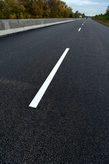 Road marking on the asphalt of the new road. Road construction.
