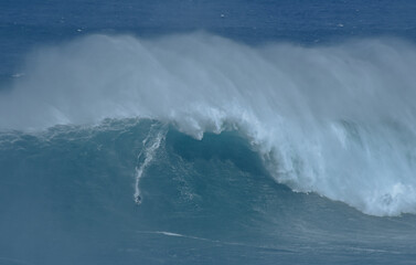 Sport photography. Jaws swell on International surfing event in Maui, Hawai 2021 December.