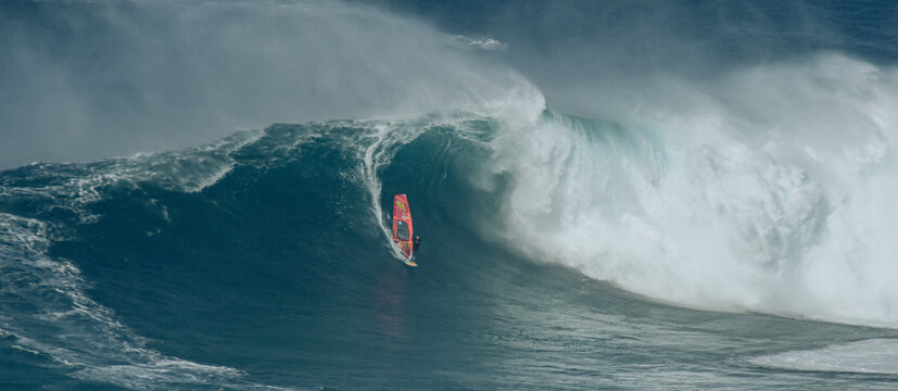 Sport photography. Jaws swell on International surfing event in Maui, Hawai 2021 December.