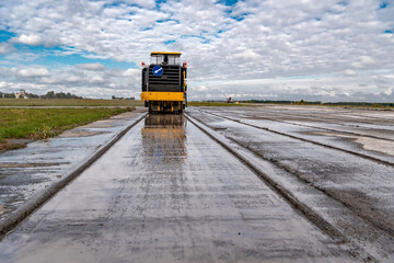 Milling machine removes the top layer of concrete on the runway for repairs
