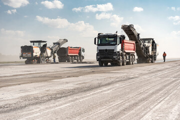 Milling machine removes the top layer of concrete on the runway for repairs