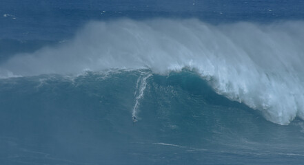 Sport photography. Jaws swell on International surfing event in Maui, Hawai 2021 December.