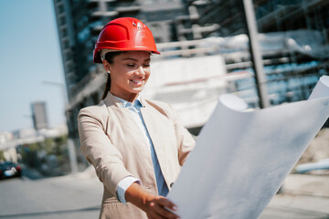 Young beautiful architect. Female engineer with her equipment..