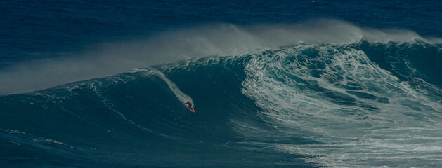 Sport photography. Jaws swell on International surfing event in Maui, Hawai 2021 December.