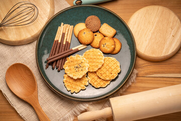 Homemade butter cookies and chocolate chip cookies and stick biscuits on wooden background ready to serve as snacks with tea and coffee on happy time.  