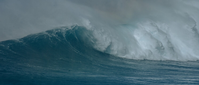 Sport photography. Jaws swell on International surfing event in Maui, Hawai 2021 December.