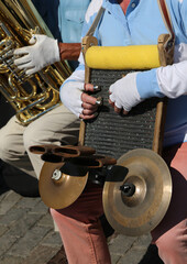 player from Eastern Europe with a particular handmade musical instrument with sound cymbals and a board where you can drag your fingers protected by thimbles