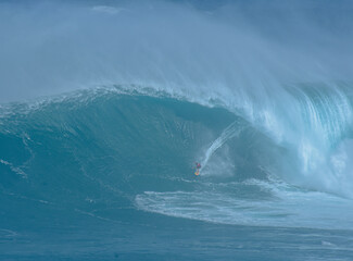 Sport photography. Jaws swell on International surfing event in Maui, Hawai 2021 December.
